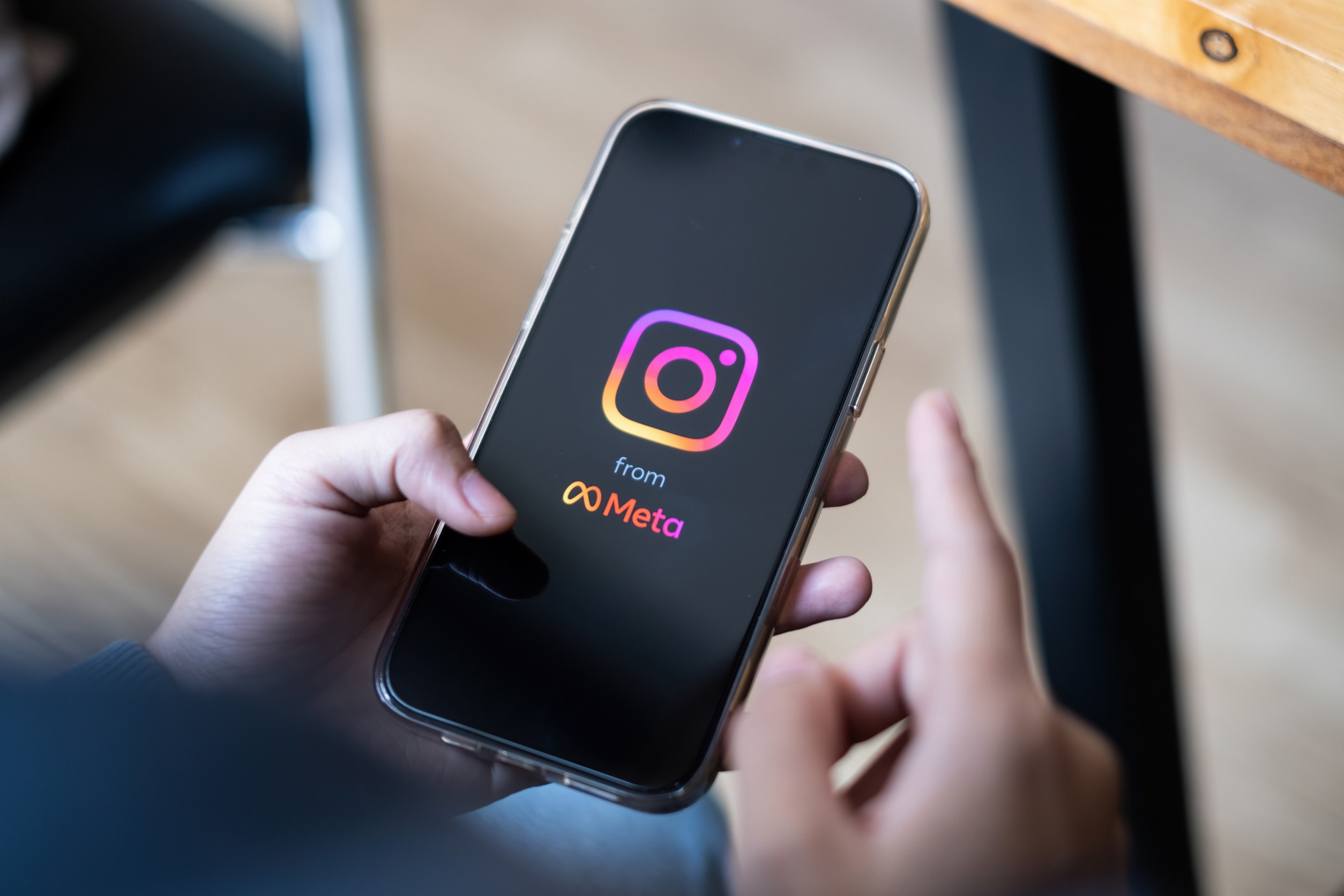 Smartphone loading Instagram with "powered by Meta" clearly visible