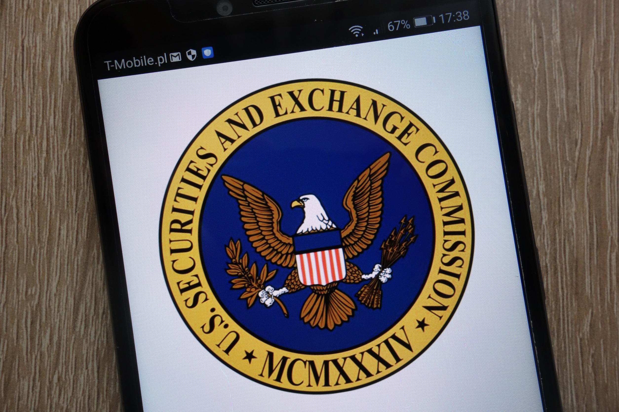 SEC seal on a smartphone screen.