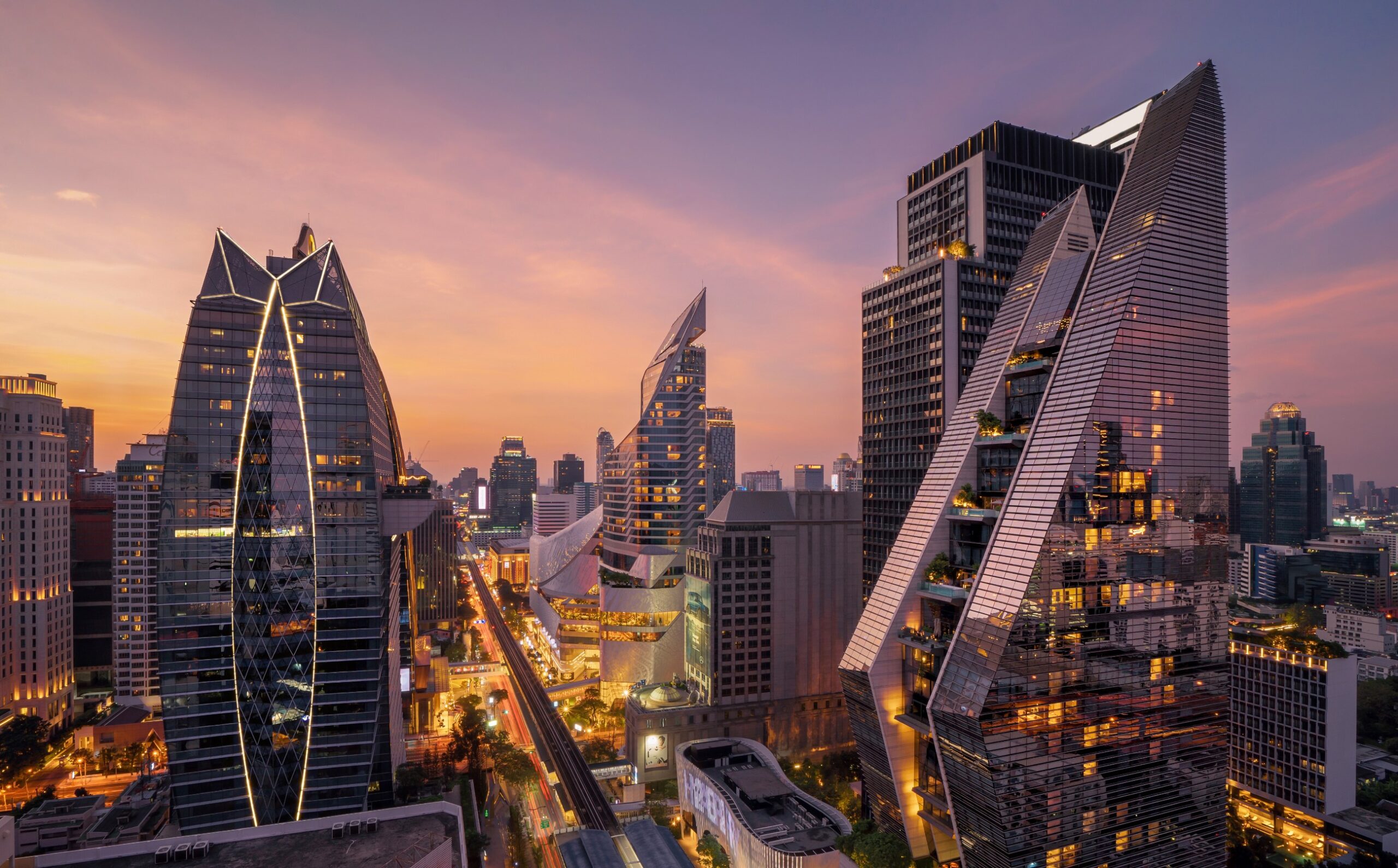 Aerial view of Ploenchit, Bangkok Downtown at night. Financial district and business centers in smart urban city in Asia. Skyscraper and high-rise buildings. Thailand
