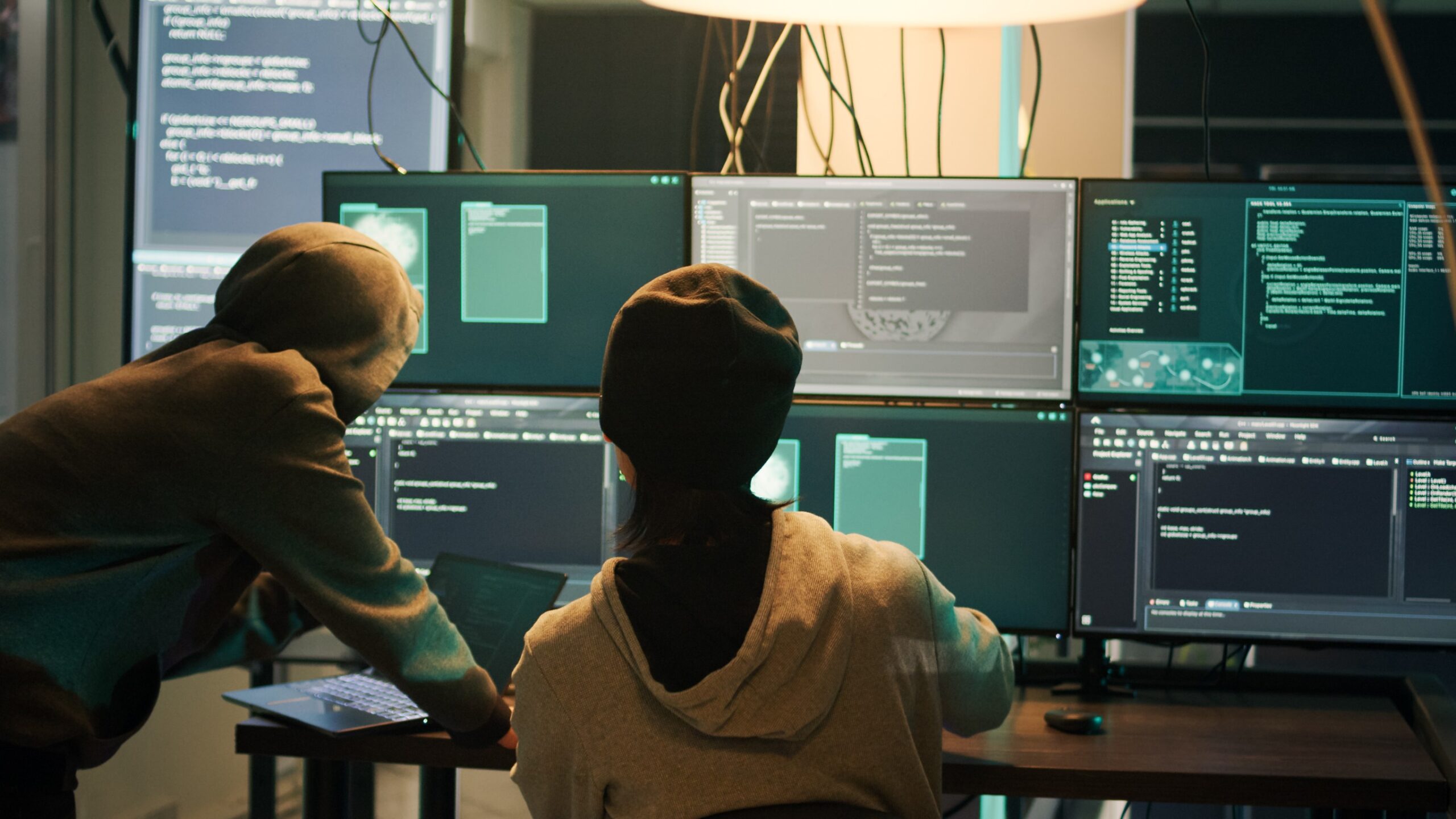 Two hackers and a lot of computer screens.